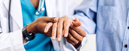 doctor holding a patients hand